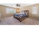 Relaxing main bedroom with plush carpet, ceiling fan and large windows for natural light at 8112 Sapphire Sea St, North Las Vegas, NV 89085