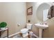 Charming powder room with pedestal sink, modern toilet, and stylish nautical-themed decor at 8112 Sapphire Sea St, North Las Vegas, NV 89085