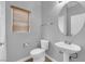 Bathroom featuring modern toilet, sink, faucet, and a round mirror at 8658 Tom Noon Ave # 103, Las Vegas, NV 89178