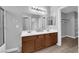 Bathroom features a double sink vanity, a large mirror, and a shower with glass doors at 8658 Tom Noon Ave # 103, Las Vegas, NV 89178