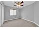 Bedroom with neutral walls, carpeted floor, ceiling fan, window with blinds, and closet at 8658 Tom Noon Ave # 103, Las Vegas, NV 89178