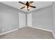 Bedroom with neutral walls, carpeted floor, ceiling fan, closet, and white doors at 8658 Tom Noon Ave # 103, Las Vegas, NV 89178