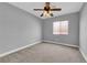 Bedroom with neutral walls, carpeted floor, ceiling fan, and window with blinds at 8658 Tom Noon Ave # 103, Las Vegas, NV 89178