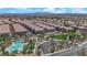 Aerial view of the community pool and park including lush landscaping, mature trees, sidewalks, and shaded picnic areas at 8658 Tom Noon Ave # 103, Las Vegas, NV 89178