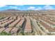 An aerial captures a vibrant community with neatly arranged homes and desert landscaping for low-maintenance living at 8658 Tom Noon Ave # 103, Las Vegas, NV 89178