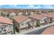 Aerial view of well-maintained homes showcasing the neighborhood's charming architecture, desert landscaping, and attached garages at 8658 Tom Noon Ave # 103, Las Vegas, NV 89178