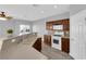 Bright kitchen featuring wood cabinets, tan countertops, and modern white appliances at 8658 Tom Noon Ave # 103, Las Vegas, NV 89178