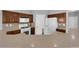Efficient kitchen featuring white appliances, dark cabinetry, and functional layout at 8658 Tom Noon Ave # 103, Las Vegas, NV 89178