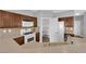 Bright kitchen featuring wood cabinets, tan countertops, and walk-in pantry at 8658 Tom Noon Ave # 103, Las Vegas, NV 89178