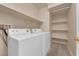Well-lit laundry room with modern machines and shelving for storage at 8658 Tom Noon Ave # 103, Las Vegas, NV 89178