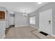 Bright living room featuring tile floors, chandelier lighting, and neutral paint at 8658 Tom Noon Ave # 103, Las Vegas, NV 89178