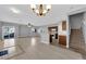 Open-concept living area with tile flooring and seamless flow into the kitchen and staircase at 8658 Tom Noon Ave # 103, Las Vegas, NV 89178