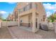 Enclosed back patio features brick accents, a white fence, and neighborhood views at 8658 Tom Noon Ave # 103, Las Vegas, NV 89178