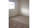 Cozy bedroom with a window, neutral walls, and plush carpet flooring, offering a comfortable living space at 8970 Flying Frog Ave, Las Vegas, NV 89148