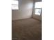 Bedroom with two windows, carpet, and neutral walls at 8970 Flying Frog Ave, Las Vegas, NV 89148