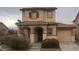 Charming two-story home with a tile roof and well-maintained front yard with stucco facade and attached garage at 8970 Flying Frog Ave, Las Vegas, NV 89148