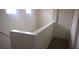 Hallway with fresh paint, leading to a door and the staircase at 8970 Flying Frog Ave, Las Vegas, NV 89148