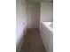 Hallway with neutral walls and plush carpet, featuring a white door and access to additional rooms at 8970 Flying Frog Ave, Las Vegas, NV 89148