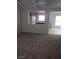 Open living room with neutral carpet and a view of the adjacent kitchen, perfect for entertaining guests at 8970 Flying Frog Ave, Las Vegas, NV 89148