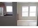 Bright and open living room with neutral walls and a glimpse into the adjacent, functional kitchen at 8970 Flying Frog Ave, Las Vegas, NV 89148