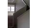 Carpeted stairs feature white banister, ascending to the next level, with natural light from the windows at 8970 Flying Frog Ave, Las Vegas, NV 89148