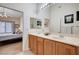 Well-lit bathroom with double sink vanity and access to an adjacent bedroom at 8985 S Durango Dr # 2014, Las Vegas, NV 89113