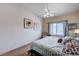 Cozy bedroom with a window view, ceiling fan, and neutral decor at 8985 S Durango Dr # 2014, Las Vegas, NV 89113