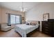 Comfortable bedroom with a ceiling fan, a chair by the window, and neutral tones at 8985 S Durango Dr # 2014, Las Vegas, NV 89113