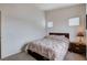 Bedroom with neutral colored walls and carpet, a bed, and natural light from two windows at 8985 S Durango Dr # 2014, Las Vegas, NV 89113