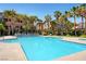 Community pool with lounge chairs and landscaping at 8985 S Durango Dr # 2014, Las Vegas, NV 89113