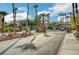 Community entrance with palm trees, gate, and manicured landscaping at 8985 S Durango Dr # 2014, Las Vegas, NV 89113