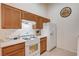 Well-equipped kitchen featuring white appliances and oak cabinets and lots of counter space at 8985 S Durango Dr # 2014, Las Vegas, NV 89113
