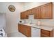 Bright kitchen featuring white appliances, oak cabinets, and ample counter space at 8985 S Durango Dr # 2014, Las Vegas, NV 89113