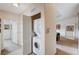 Hallway featuring a stacked washer and dryer unit with access to adjacent rooms at 8985 S Durango Dr # 2014, Las Vegas, NV 89113