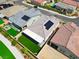 Overhead view of backyards featuring solar panels, covered patios, artificial turf, and outdoor living spaces at 9057 N Skye Treeline St, Las Vegas, NV 89166