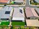 Aerial perspective of homes with solar panels, artificial grass, and manicured landscaping in a planned community at 9057 N Skye Treeline St, Las Vegas, NV 89166