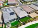 High-angle shot of homes with solar panels, artificial grass, and manicured lawns within a residential area at 9057 N Skye Treeline St, Las Vegas, NV 89166