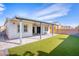 Low maintenance backyard featuring artificial turf, covered patio and a block wall at 9057 N Skye Treeline St, Las Vegas, NV 89166
