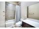 Bathroom showcasing a shower-tub combination, toilet, and modern vanity with a framed mirror at 9057 N Skye Treeline St, Las Vegas, NV 89166