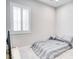 Minimalist bedroom design featuring a large window, comfortable bed, and neutral decor for a peaceful retreat at 9057 N Skye Treeline St, Las Vegas, NV 89166