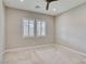 Neutral bedroom with carpet, ceiling fan, two windows and white window shutters at 9057 N Skye Treeline St, Las Vegas, NV 89166