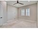 Neutral bedroom with carpet, ceiling fan, two windows and white window shutters at 9057 N Skye Treeline St, Las Vegas, NV 89166
