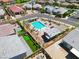 Aerial view of a community pool area with lounge chairs, umbrellas, and manicured landscaping, enhancing outdoor appeal at 9057 N Skye Treeline St, Las Vegas, NV 89166