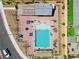 High-angle shot of a community pool featuring various seating options, lush landscaping, and recreational amenities at 9057 N Skye Treeline St, Las Vegas, NV 89166
