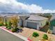 Charming single-story home featuring a two-car garage, tile roof, desert landscaping, and a mountain backdrop at 9057 N Skye Treeline St, Las Vegas, NV 89166