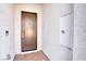 Contemporary front entry featuring a bronze door, exterior lighting, and modern stucco at 9057 N Skye Treeline St, Las Vegas, NV 89166