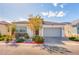 Beautiful single-story home featuring desert landscaping, a two car garage, and a modern stucco facade at 9057 N Skye Treeline St, Las Vegas, NV 89166