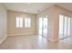 Bright open-plan living room featuring tile floors, neutral colors and plenty of natural light at 9057 N Skye Treeline St, Las Vegas, NV 89166