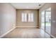 Inviting living room with natural light, neutral walls, and wood-look tile flooring at 9057 N Skye Treeline St, Las Vegas, NV 89166