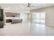 Bright open-concept living space showcasing the kitchen, with a large sliding door leading to a patio at 9057 N Skye Treeline St, Las Vegas, NV 89166